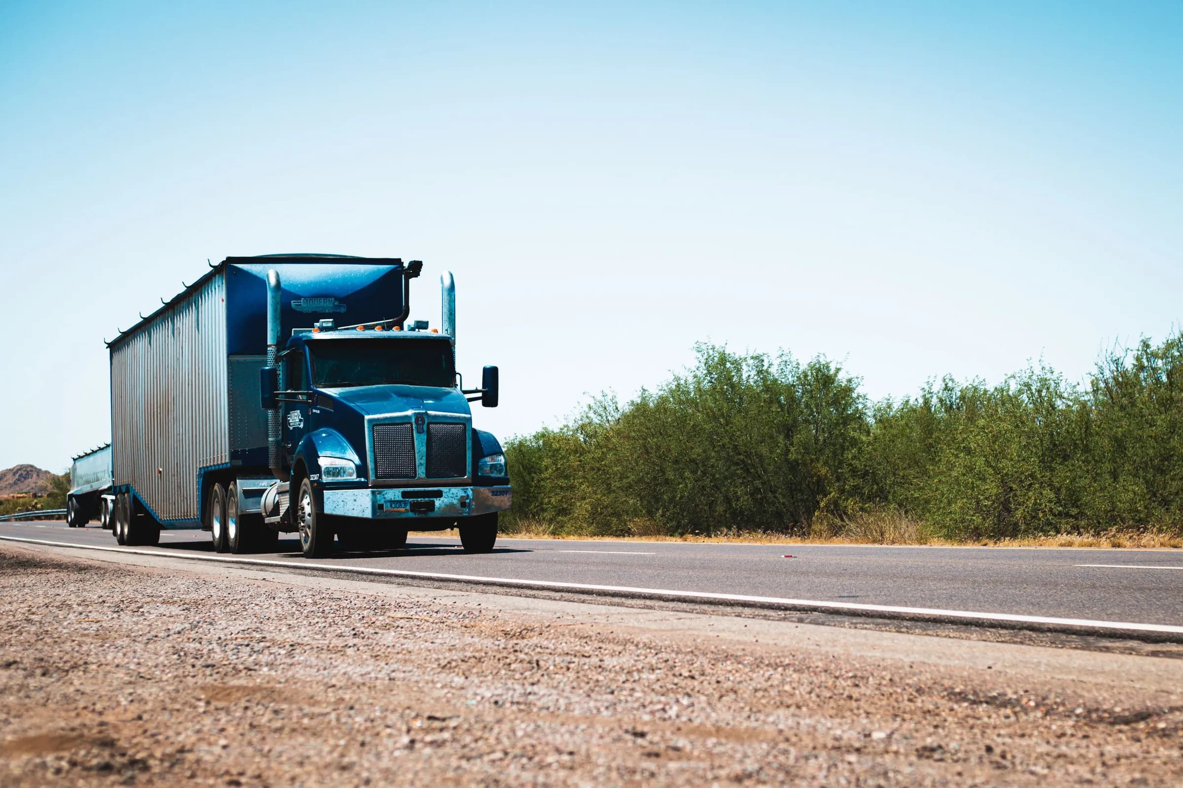 Blue semi-truck on an open highway