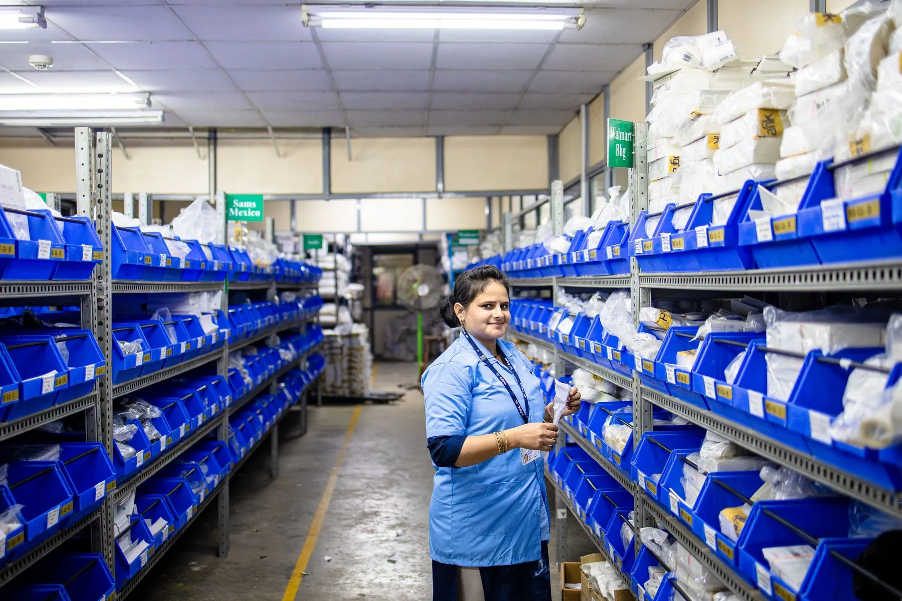 Parts specialist checking stock on organised shelving